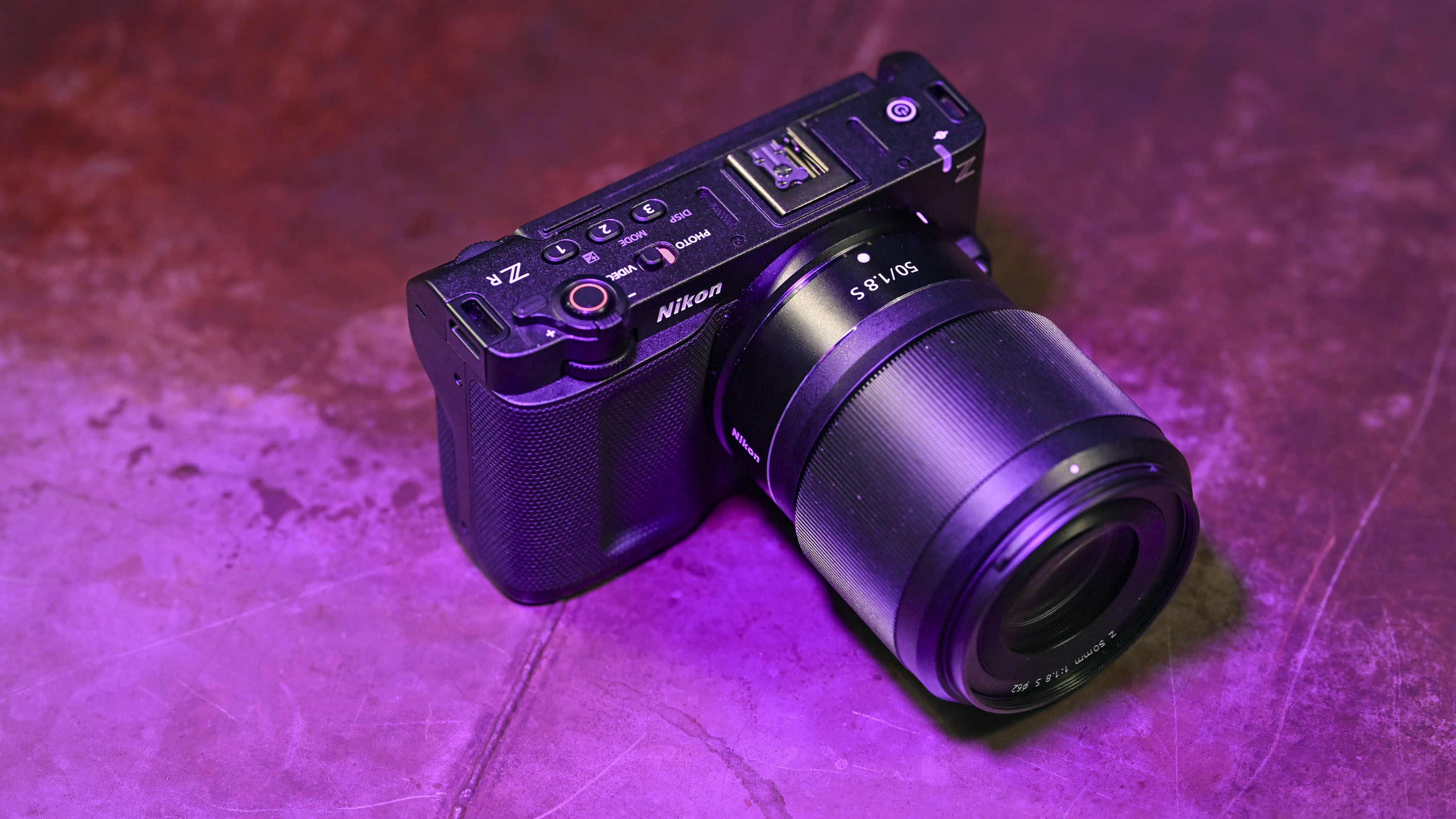Top of Nikon ZR camera under low key magenta lighting