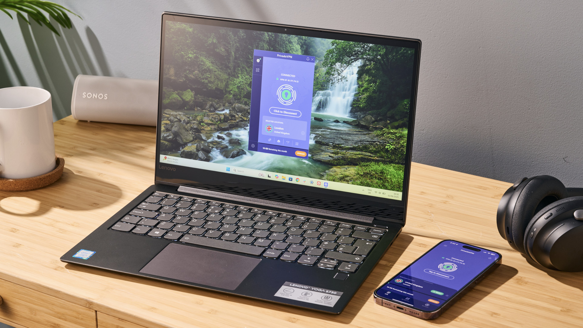PrivadoVPN Free apps running on an open laptop and a mobile, lying on a desk.